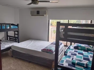 two bunk beds in a room with a window at Apartamento Villa Saika in Coveñas
