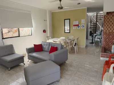 a living room with a couch and chairs and a table at Apartamento Villa Saika in Coveñas