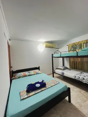 a room with two bunk beds and a blue bag on it at Apartamento Villa Saika in Coveñas