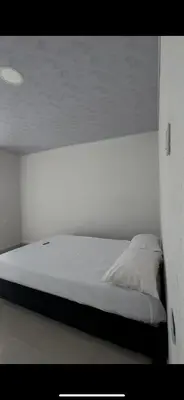 a bed in a white room with at Cabaña Eterno Nirvana in Santa Veronica