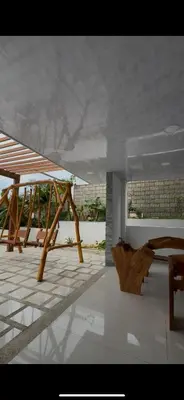 a group of picnic tables and benches on a patio at Cabaña Eterno Nirvana in Santa Veronica