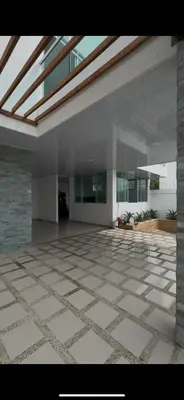 a large room with a stone floor and a building at Cabaña Eterno Nirvana in Santa Veronica