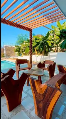 a patio with a table and chairs and a pool at Cabaña Eterno Nirvana in Santa Veronica