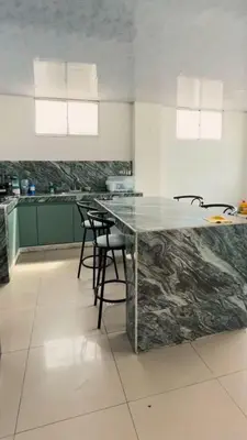 a kitchen with a large marble counter top in a room at Cabaña Eterno Nirvana in Santa Veronica