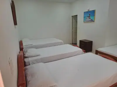 a group of four beds in a room at Finca Villa Gabriela