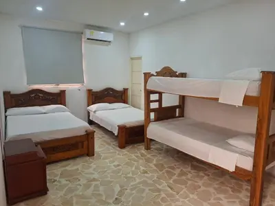 a room with two bunk beds and a chalkboard at Finca Villa Gabriela