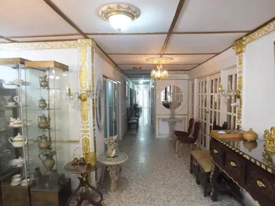 a hallway with a room filled with items on display at Hotel Nuevo Horizonte in Barranquilla