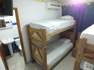 a bathroom with two bunk beds in a room at Hotel Nuevo Horizonte in Barranquilla