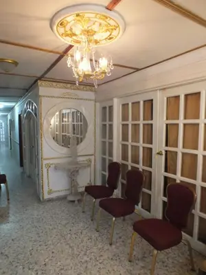 a room with chairs and a chandelier at Hotel Nuevo Horizonte in Barranquilla