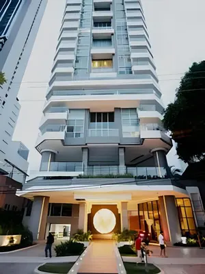a tall white building with people walking in front of it at Beachfront Bocagrande Stay | Breathtaking Sunsets in Cartagena de Indias