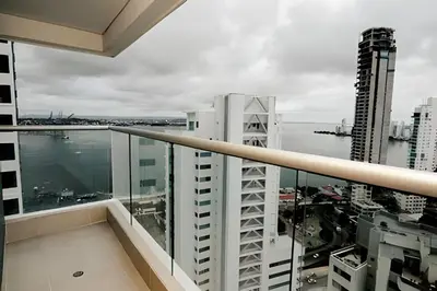 a balcony with a view of a city at Beachfront Bocagrande Stay | Breathtaking Sunsets in Cartagena de Indias