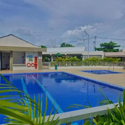 a swimming pool in front of a gas station at Apartmento en Parque Heredia in Cartagena de Indias