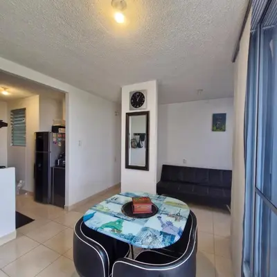 a living room with a table and a couch at Apartmento en Parque Heredia in Cartagena de Indias