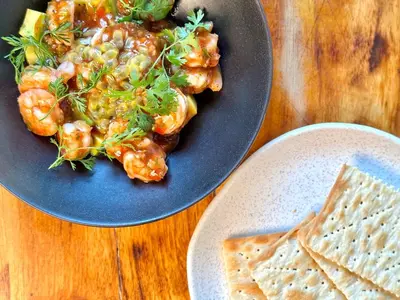 a blue plate of food with shrimp and pita bread at Masaya Cartagena in Cartagena de Indias