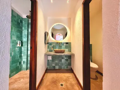 a bathroom with a sink and a mirror at Masaya Cartagena in Cartagena de Indias