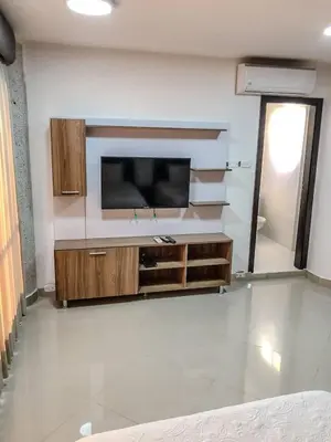 a living room with a flat screen tv on a wall at Lofts Mediterraneo in Barranquilla