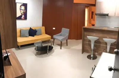 a living room with a couch and a chair at Lofts Mediterraneo in Barranquilla