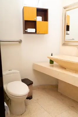 a bathroom with a toilet and a sink and a mirror at Villa exclusiva junto al mar en Cartagena in Cartagena de Indias