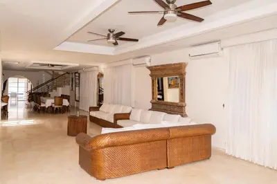 a living room with a couch and a ceiling fan at Villa exclusiva junto al mar en Cartagena in Cartagena de Indias