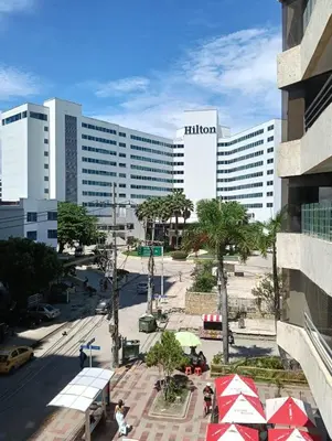 a hilton hotel with a street in front of a building at Acogedor Apartaestudio Laguito 1 Habitacion N4A2 in Cartagena de Indias