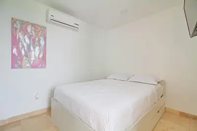 a white bedroom with a bed in a room at Sonesta Resort Apartamento Morros Cartagena in Cartagena de Indias