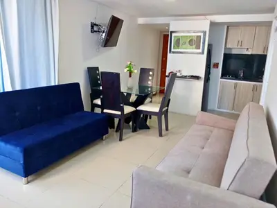 a living room with a couch and a dining table at Atardeceres del Laguito in Cartagena de Indias
