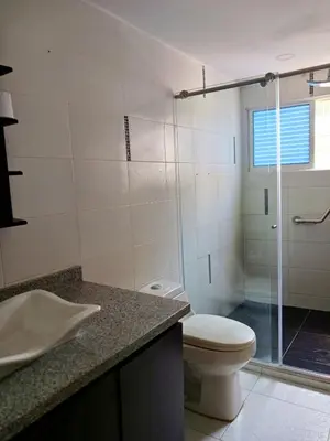 a bathroom with a toilet and a glass shower at Atardeceres del Laguito in Cartagena de Indias