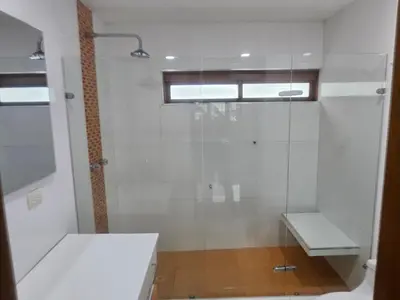 a bathroom with a glass shower and a toilet at Migo in Cartagena de Indias