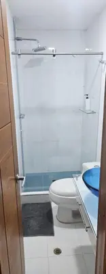 a bathroom with a toilet and a glass shower at Migo in Cartagena de Indias