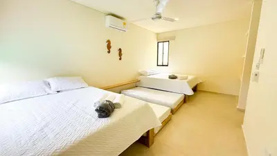 a bedroom with two beds and a window at Cabaña Tierramia 3 in San Silvestre