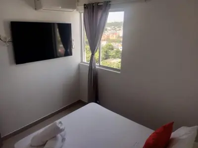 a small bedroom with a bed and a window at nice and affordable in Cartagena de Indias