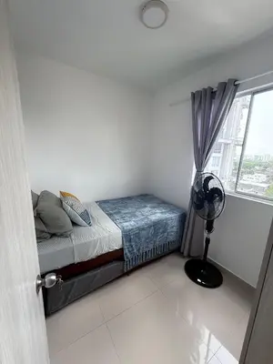 a bedroom with a bed and a window with a fan at nice and affordable in Cartagena de Indias