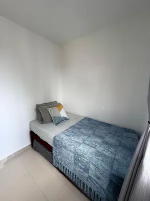 a small bedroom with a bed and white walls at nice and affordable in Cartagena de Indias
