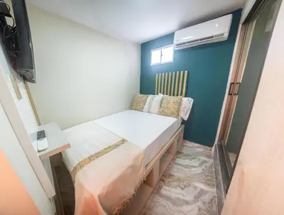 a small bedroom with a bed and a television at Sublime Hotel Cartagena in Cartagena de Indias