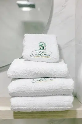 a stack of towels on a shelf in a bathroom at Sublime Hotel Cartagena in Cartagena de Indias