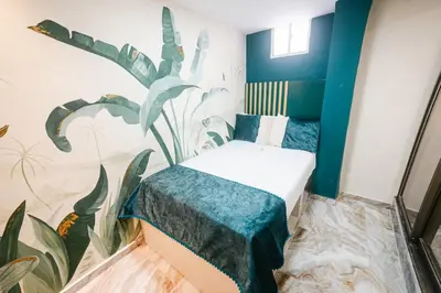 a room with a bed with a mural on the wall at Sublime Hotel Cartagena in Cartagena de Indias