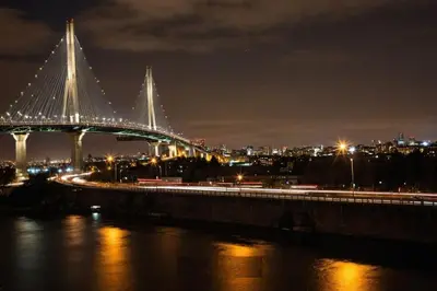a bridge over a river with a city at night at Apartamentos Palmar - Excelente Ubicación by SOHO in Barranquilla