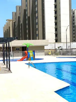a swimming pool with a playground in a city at Apartamentos Palmar - Excelente Ubicación by SOHO in Barranquilla
