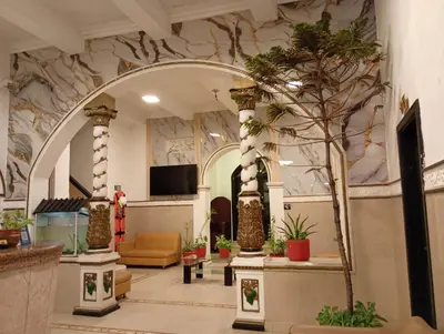 a lobby with an archway with potted plants at Hotel Girasol Inn Barranquilla in Barranquilla