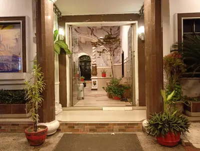 a hallway with potted plants in a building at Hotel Girasol Inn Barranquilla in Barranquilla