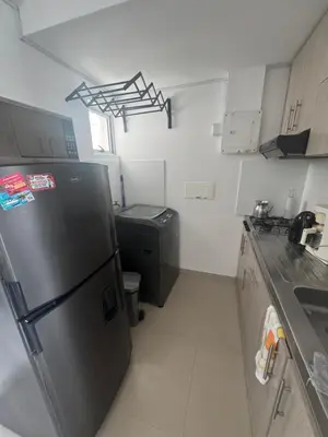 a kitchen with a refrigerator and a trash can at Great and affordable in Cartagena de Indias