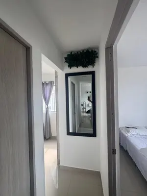 a bedroom with a mirror on the wall and a bed at Great and affordable in Cartagena de Indias