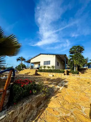 a white house on a hill with a tree at Liz&Mar in El Morro