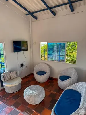 a room with wicker chairs and tables and windows at Liz&Mar in El Morro