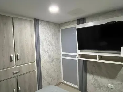 a living room with a large television in a room at Aparta estudio confortable y completo in Barranquilla