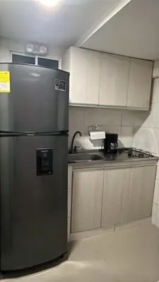 a kitchen with a stainless steel refrigerator and a sink at Aparta estudio confortable y completo in Barranquilla