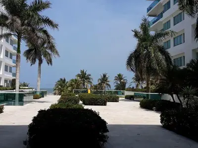 a resort with palm trees and a building at Stunning 2BD Apartment Pool - Oceanview Cartagena in Cartagena de Indias