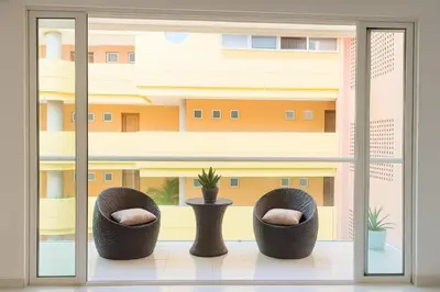 a room with two chairs in front of a window at Stunning 2BD Apartment Pool - Oceanview Cartagena in Cartagena de Indias