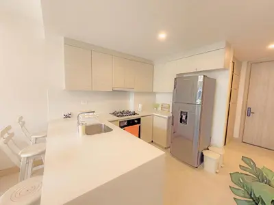 a kitchen with a sink and a refrigerator at Apart Suítes Stay Morros EOS - Acceso directo a la playa in Cartagena de Indias