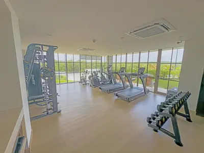 a gym with rows of treadmills and exercise equipment at Apart Suítes Stay Morros EOS - Acceso directo a la playa in Cartagena de Indias
